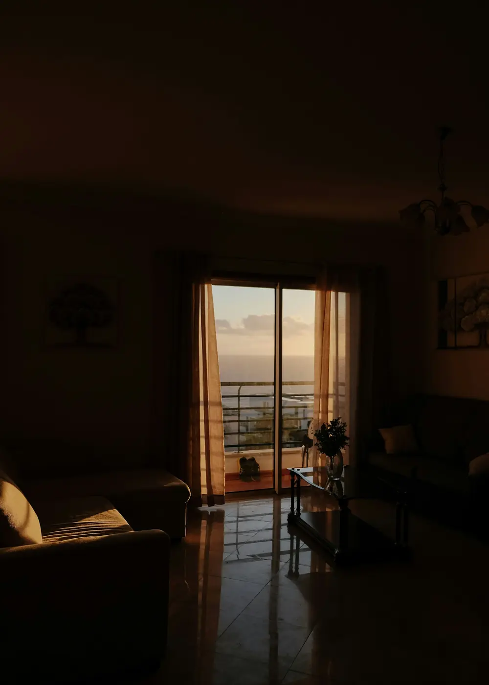 A guest looking out over the water from a sunlit sitting room
